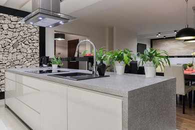 Photo of a contemporary eat-in kitchen in Wilmington with solid surface benchtops and with island.