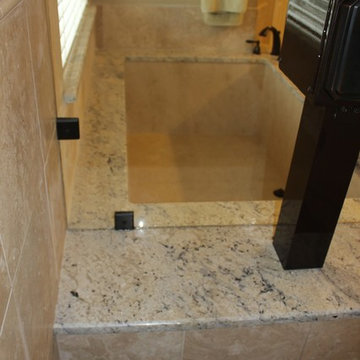 Undermount Marble Tub with Bianco Romano Granite and Frameless Shower
