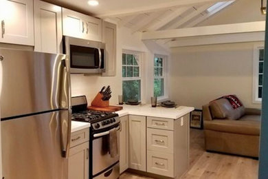 Example of a small classic u-shaped light wood floor and beige floor open concept kitchen design in San Francisco with shaker cabinets, quartz countertops, stainless steel appliances, a peninsula, white countertops and gray cabinets