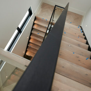 Dynamic Angled View of Modern Glass-and-Wood Staircase
