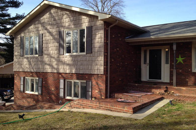 Example of a large classic beige two-story wood exterior home design in Charlotte