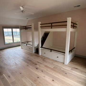 Spacious Shared Kids Room with Custom Bunk Beds, Integrated Drawers, and Vaulted