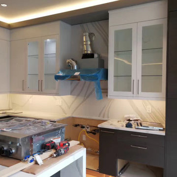 EUROPEAN FRAMELESS KITCHEN CABINETS WITH CALACATTA GOLD WATERFALL COUNTERTOPS