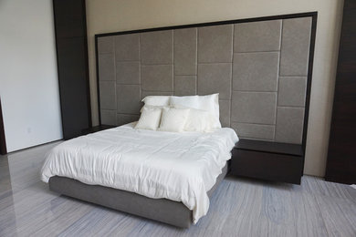 Inspiration for a large contemporary master bedroom in Miami with white walls and grey floor.