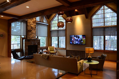 Mid-sized trendy open concept light wood floor and brown floor living room photo in Denver with beige walls, a standard fireplace, a stone fireplace and a wall-mounted tv