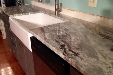 Large elegant medium tone wood floor kitchen photo in Nashville with a drop-in sink, raised-panel cabinets, granite countertops, stainless steel appliances and an island