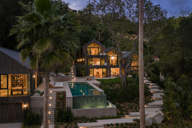 Inspiration for a large contemporary brown three-story wood and clapboard exterior home remodel in Los Angeles with a metal roof and a gray roof
