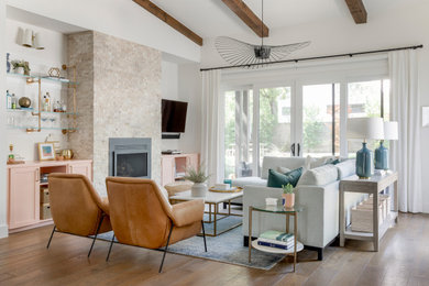 Mid-sized trendy formal and open concept medium tone wood floor and exposed beam living room photo in Austin with white walls, a standard fireplace, a metal fireplace and a wall-mounted tv