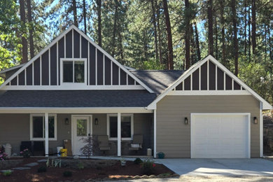 Inspiration for a small contemporary beige two-story wood and board and batten exterior home remodel in Seattle with a shingle roof and a gray roof