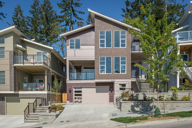 Example of a trendy multicolored three-story house exterior design in Vancouver