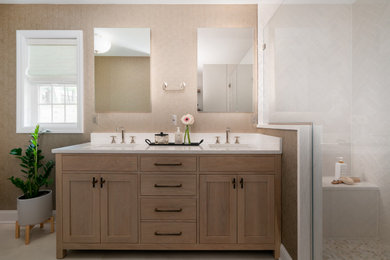 Inspiration for a mid-sized transitional master white tile and porcelain tile ceramic tile, beige floor, double-sink and wallpaper bathroom remodel in New York with shaker cabinets, light wood cabinets, a one-piece toilet, beige walls, an undermount sink, quartz countertops, a hinged shower door, beige countertops and a freestanding vanity