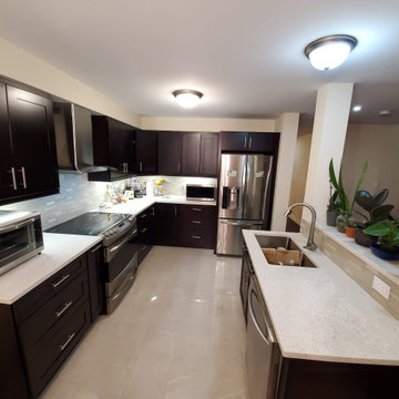 Dark brown kitchen with quartz counter top