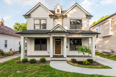 Example of a classic white three-story exterior home design in Detroit