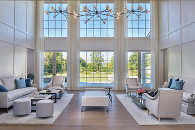 Living room - large transitional formal and enclosed medium tone wood floor living room idea in New York with white walls and no fireplace