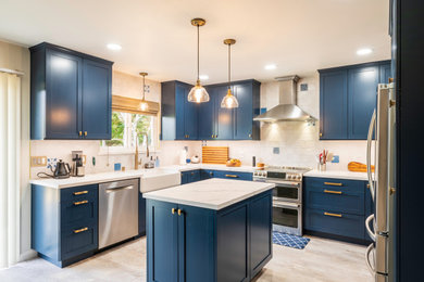Large eclectic u-shaped beige floor and ceramic tile eat-in kitchen photo in San Luis Obispo with a farmhouse sink, shaker cabinets, blue cabinets, quartz countertops, white backsplash, ceramic backsplash, stainless steel appliances, an island and white countertops