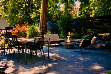 Minimalist backyard tile patio photo in Vancouver with a fire pit