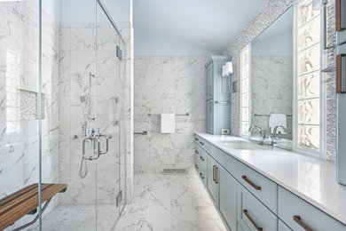 Inspiration for a coastal multicolored tile and porcelain tile porcelain tile, multicolored floor and single-sink bathroom remodel in Milwaukee with shaker cabinets, blue cabinets, blue walls, an undermount sink, quartz countertops, a hinged shower door, white countertops and a built-in vanity