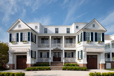 Large beach style white three-story wood and shingle exterior home photo in Philadelphia with a shingle roof and a brown roof