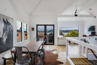 Great room - mid-sized scandinavian light wood floor and brown floor great room idea in San Francisco with white walls and no fireplace