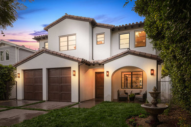 Inspiration for a mediterranean white two-story stucco gable roof remodel in Los Angeles