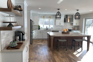 Eat-in kitchen - large transitional l-shaped vinyl floor and brown floor eat-in kitchen idea in Other with an undermount sink, shaker cabinets, white cabinets, quartz countertops, stainless steel appliances, an island and gray countertops