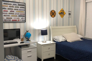 Example of a mid-sized transitional boy dark wood floor and brown floor kids' room design with blue walls