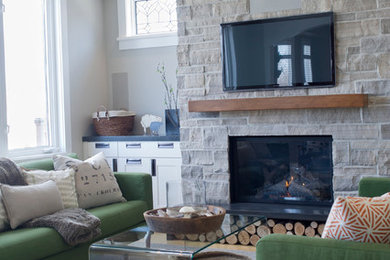 Mid-sized transitional carpeted family room photo in Toronto with gray walls, a standard fireplace, a stone fireplace and a wall-mounted tv