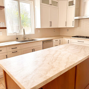 Taj Mahal Quartzite Kitchen, White Shakers and Wood Island