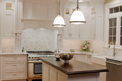 This is an example of a large traditional u-shaped eat-in kitchen in Philadelphia with a single-bowl sink, shaker cabinets, wood benchtops, white splashback, subway tile splashback, panelled appliances, medium hardwood floors, with island and white cabinets.
