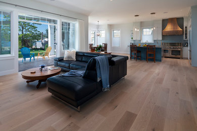 Inspiration for a mid-sized coastal open concept light wood floor and beige floor living room remodel in Other with gray walls