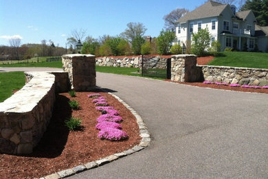 Inspiration for a huge traditional full sun front yard stone landscaping in Boston for spring.