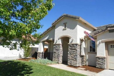 Inspiration for a beige one-story exterior home remodel in Phoenix