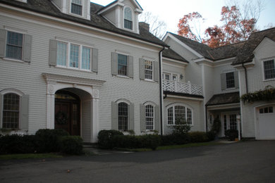 Example of a huge gray two-story vinyl exterior home design in New York