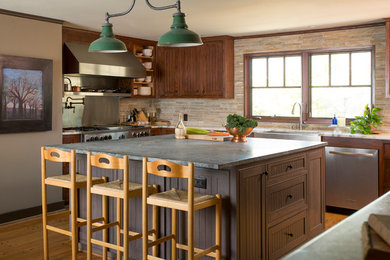 Kitchen - rustic u-shaped kitchen idea in Dallas with a farmhouse sink, shaker cabinets, dark wood cabinets, soapstone countertops, beige backsplash, matchstick tile backsplash, stainless steel appliances and an island