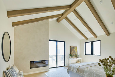 Example of a large minimalist master light wood floor, beige floor and exposed beam bedroom design in Los Angeles with beige walls and a corner fireplace