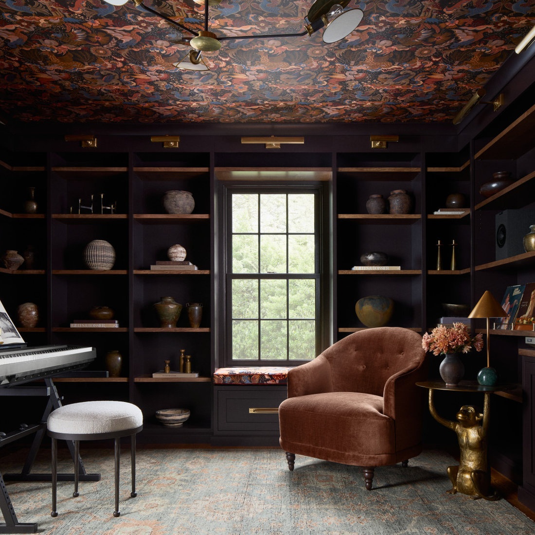 Family room - transitional medium tone wood floor and brown floor family room idea in Philadelphia with black walls