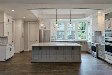Inspiration for a large transitional medium tone wood floor and coffered ceiling open concept kitchen remodel in Raleigh with a farmhouse sink, shaker cabinets, quartzite countertops and an island