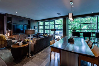 Family room - large modern enclosed carpeted family room idea in Calgary with brown walls and a media wall