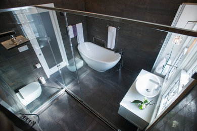 Bathroom - mid-sized contemporary master white tile and stone tile ceramic tile bathroom idea in Other with flat-panel cabinets, white cabinets, a one-piece toilet, black walls, a drop-in sink and soapstone countertops