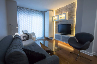 Living room - small contemporary enclosed medium tone wood floor living room idea in Ottawa with gray walls and a media wall