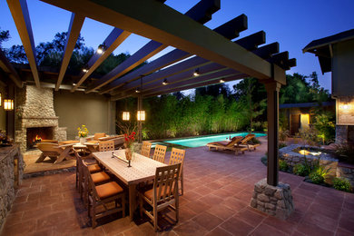 Patio fountain - large mediterranean backyard tile patio fountain idea in Orange County with no cover
