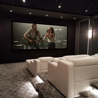 Photo of a contemporary enclosed home cinema in New York with grey walls, carpet and grey floors.