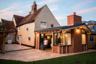 Inspiration for a contemporary brick extension in Other with a metal roof.