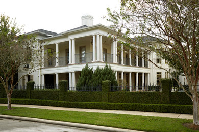 Inspiration for a large traditional two-storey brick white house exterior in Houston with a hip roof and a shingle roof.