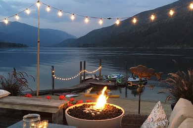 Example of a large beach style backyard patio design in Vancouver with decking and no cover
