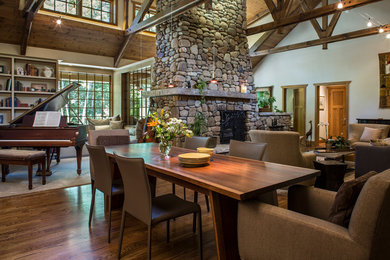 Great room - traditional medium tone wood floor great room idea in Other with a two-sided fireplace and a stone fireplace