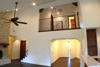 Living room - traditional open concept dark wood floor living room idea in Austin with white walls, a standard fireplace and a stone fireplace