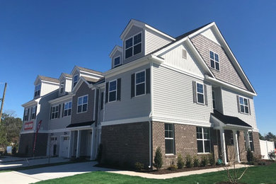 Trendy townhouse exterior photo in Other