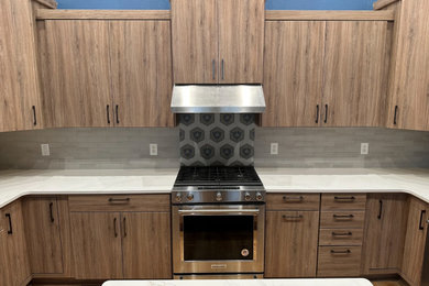 Inspiration for a mid-sized transitional u-shaped eat-in kitchen remodel in Other with flat-panel cabinets, quartz countertops and an island