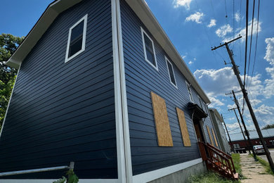 Inspiration for a mid-sized timeless blue two-story concrete fiberboard exterior home remodel in Louisville with a shingle roof and a black roof
